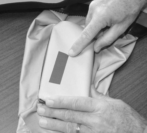 Cover the patch and your dry-suit fabric with parchment paper before applying heat. Take your heated iron and apply pressure. Keep the iron moving in a circular motion.