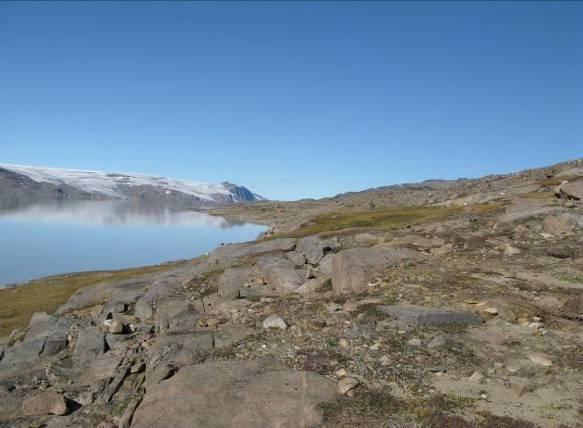 Culture Historical Significance of the Finds Fig. 6: View toward west from the easternmost settlement (66V2-0II-067) at Tasersiaq. Fig. 7: Archaeologists looking for diagnostic tools in a tentring from the Saqqaq Culture at Tasersiaq.