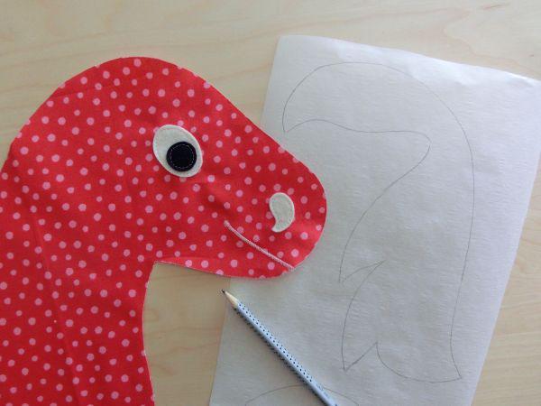 Applique the eye and the nostril with a fancy or a straight stitch. Sew the mouth with a narrow zig-zag line.
