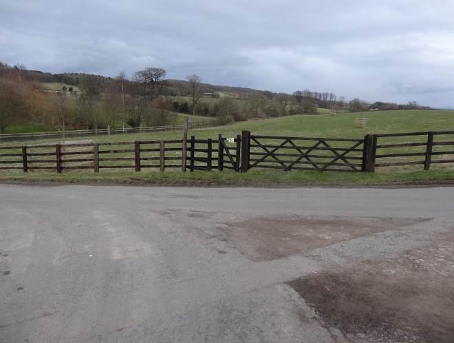 cross a field: Go through a number of kissing gates at field boundaries until you reach the road.