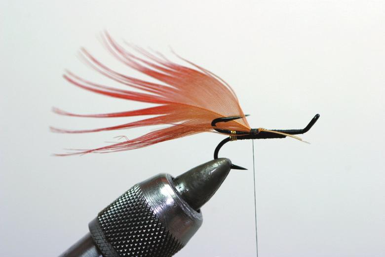 The rear body may be tied with flat mylar and a rib or large oval tinsel in touching turns. The large oval tinsel body is generally considered to make a better fishing fly.