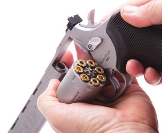 Holding the gun with the muzzle pointing downward and in a safe direction, and the cylinder in its outermost position, insert all seven cartridges at once
