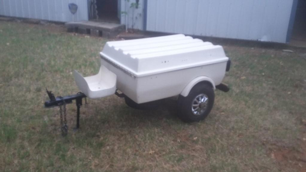 Nice little light weight fiberglass trailer. Has wood bumper which has been refinished. Cooler holder on the front.
