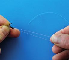 How to tie a L-rig with stopknot 1 Thread the tippet through the eye and lay it parallel back along the