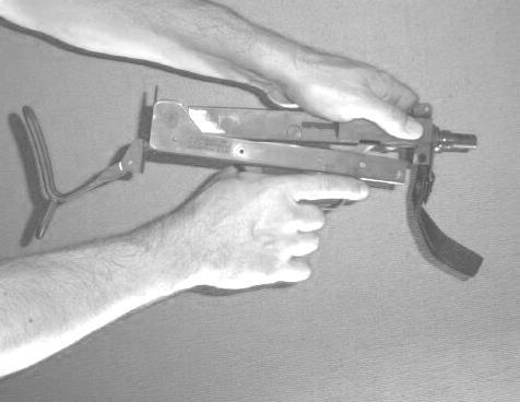 2 While holding cocking knob, pull trigger and ease bolt