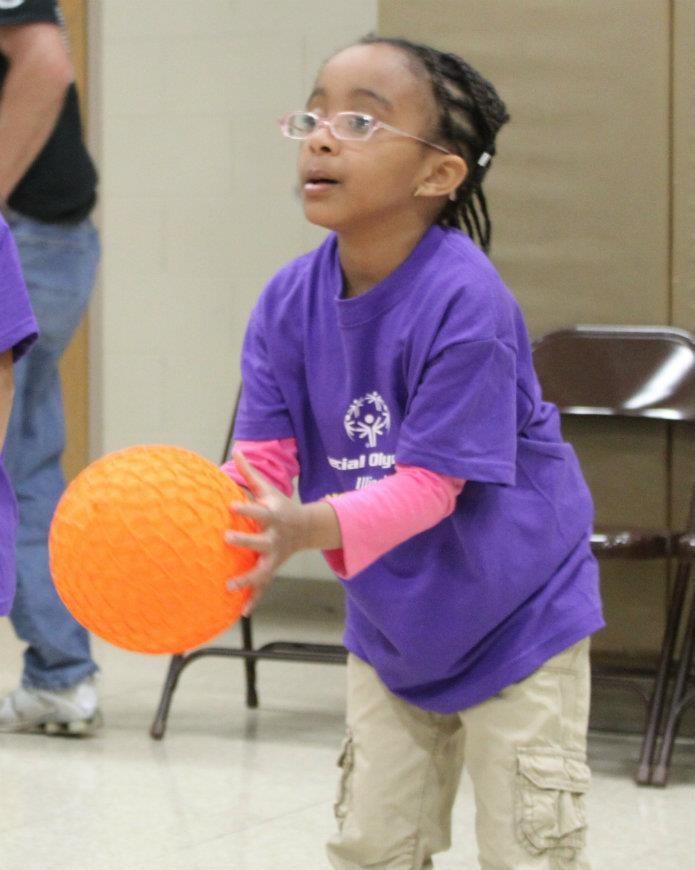 Ask the child to look at your hands and toss the ball underhand to your hands. Progress to tossing an object through a hoop or toward a target.