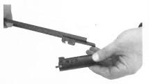 11. To disassemble the bolt from the bolt carrier, remove the charging handle out of the bolt and upper receiver. Locate and center the charging handle under the crescent cut.