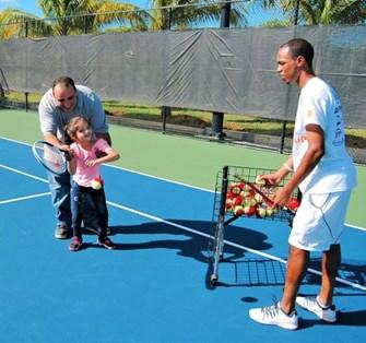 Coaches playing tennis with children with Special Needs on court at the ATA.