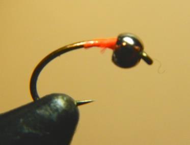 You want to build a small base of thread up near the hook eye so you can slide the bead over it.