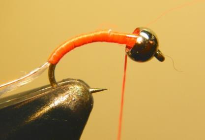 Half hitch the thread, slide the bead forward (Fig 3), reattach the thread and attach the copper wire on top of the hook shank.
