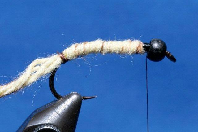 Instructions 1. Lay down a thread base. Place the bead on the hook and fix the hook in the vise. Move the bead forward to the hook eye.