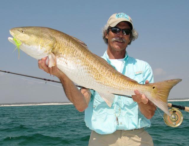 Here's a nice shot of Walter with a typical redfish lit up in it's orange finest.