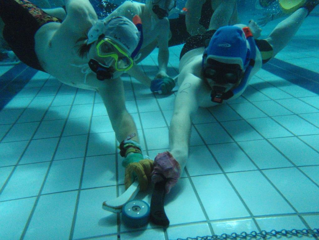 UNDERWATER HOCKEY Underwater team sport Puck on the bottom of the pool First world