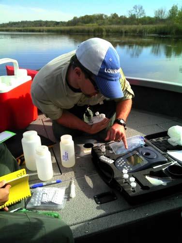 Figure 12. Keegan Lund, Invasive Species Specialist, using the photometer to measure copper concentrations in the herbicide treatment area on Mud Lake, Stearns County (DOW 73020001).