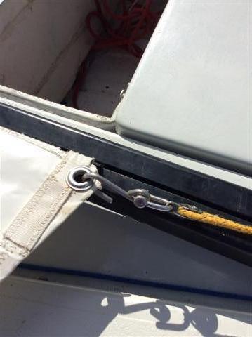 If the mainsail is not yet on the boom, then slide the foot of the sail into the boom slot.