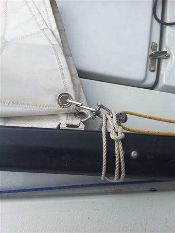 Pull it all the way to the top and tie off with figuresof-eight on the mast cleat. Put the end of the boom onto the gooseneck and attach the kicking strap. Tidy up the tail of the halyard.