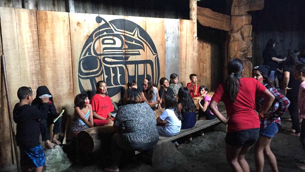 Heiltsuk youth singing and dancing in traditional big house on the