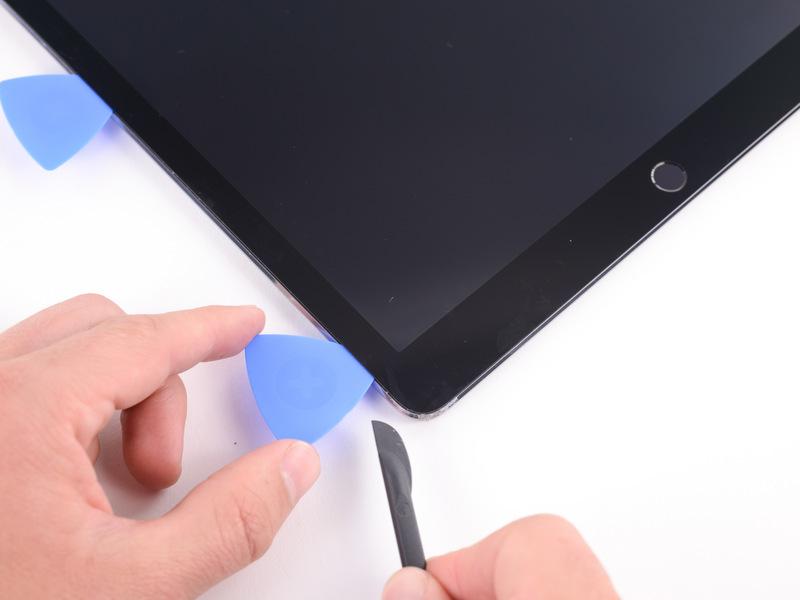 Step 10 Insert a pick in the bottom left corner of the ipad to ensure that the adhesive doesn't