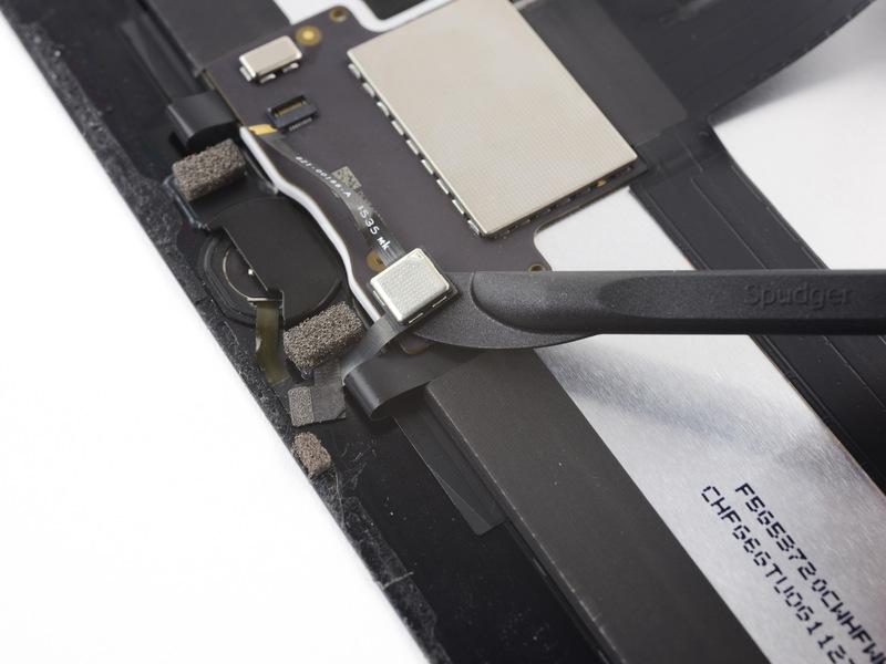 the adhesive holding the home button cable in place.