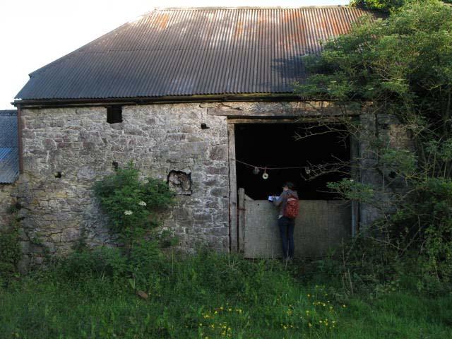 Barn has wide doorway on higher ground at rear; narrow doorway at front. Used historically for housing livestock, now for occasional storage. Lower room retains original animal stalls.