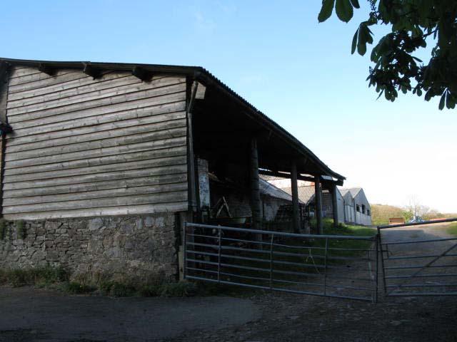 Openfronted on north side facing onto courtyard with sections of timber panelling. Eastern end used for housing llamas; western end as storage shed.