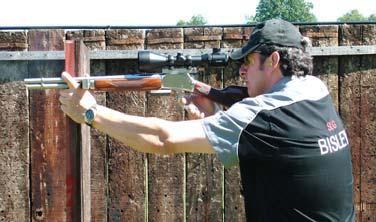 Shooting on the left side of the barricade, place the left index finger over the top of the barrel with the thumb and remaining fingers underneath the magazine tube.