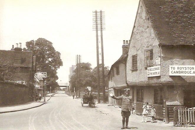 ABOVE: An AA man directs traffic because King George V is expected to drive through Baldock.
