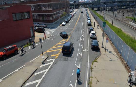 Vehicles drive over buffered bike lane in order to beat the queue High Cyclists Volumes from Queens