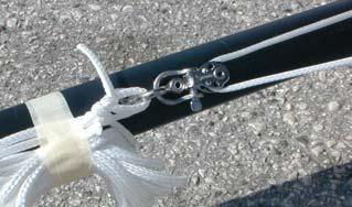 Once the jib is hoisted, attach the carbo block (5) with shackle to the jib clew and use the yellow sheet rope to trim.