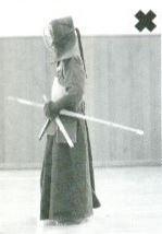 3) When you do Osame, put your right-hand Shinai away first by transferring it to hold (Osameru, Kensen backward) on your left hand with your left-hand Shinai and then with your right