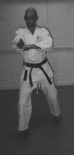 Make uchi uke and gedan barai with the opposite arms. Look over your right shoulder.