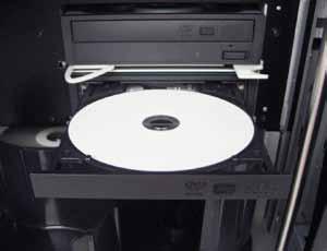 操作 Professional 3400 和 5400N 系统将光盘放在刻录机托盘上 使用此规程以手动将光盘放在刻录机托盘上 1.
