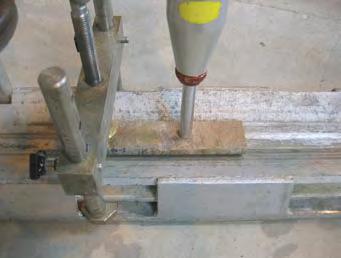 For measurements of JCS, r and R, a Schmidt hammer with a clamp to fasten the samples is