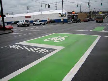 Bike boxes can be combined with dashed lines through the intersection for green light situations to remind right-turning motorists to be aware of bicyclists traveling straight, similar to the colored