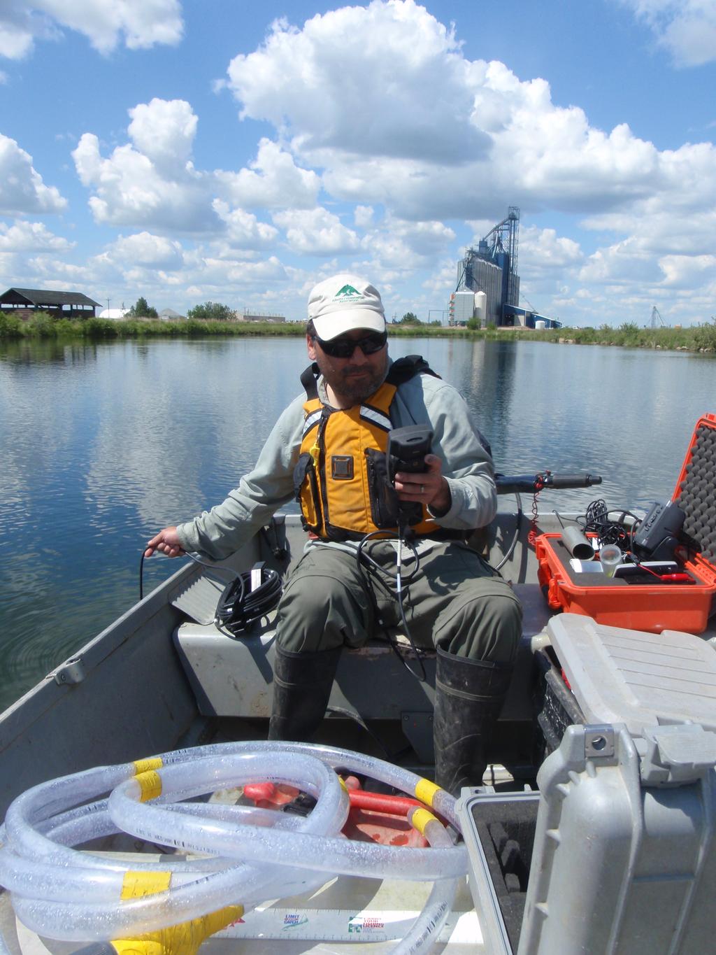 Alberta Conservation Association staff member Troy Furukawa collecting water quality data