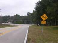 Issue: Advance Curve and Intersection Warning Daly Road intersects Lake Lindsey Road on a curve. There are curve warning signs on Lake Lindsey Road, but there are no intersection warning signs.