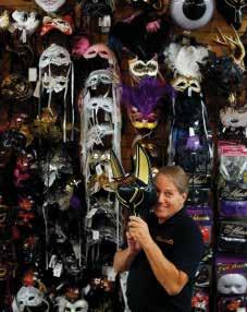 Costumania owner Mark Young holds a mask of Anubis, Egyptian god of the underworld, in front of