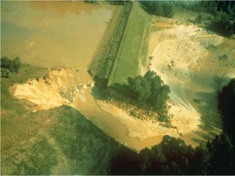 Figure 6. Black Creek Site 53 following breach of auxiliary spillway (Temple, 1989). This auxiliary spillway example illustrates the importance of inspection, maintenance, and owner education.