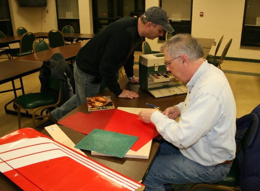 Repair Clinic TICO Warbird Airshow At our March meeting I brought both halves of the wing, damaged and undamaged, as Roger did a trace of the undamaged wing on a thin plastic red sheeting, he said