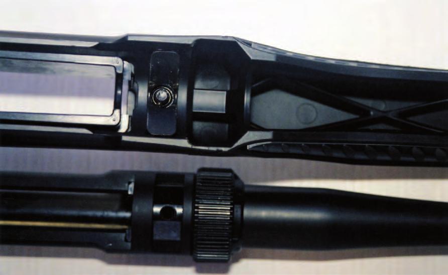 RIGHT: Top, a V-shaped section of the barrel extension viewed through a slot in the bottom the the receiver is bedded on an identically shaped lug embedded in the rifle stock.