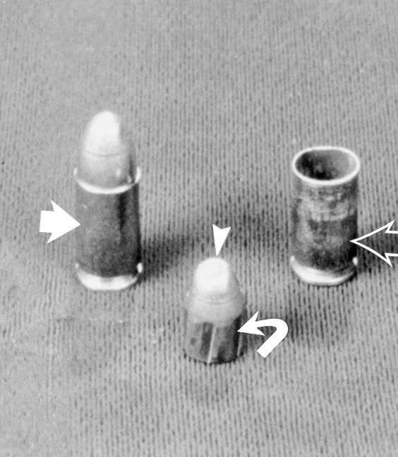 ) (a) Photograph of fully jacketed 9-mm hadgu rouds shows lack of deformatio of the bullet ad the spiral riflig marks (curved arrow) o the sides of the bullet.