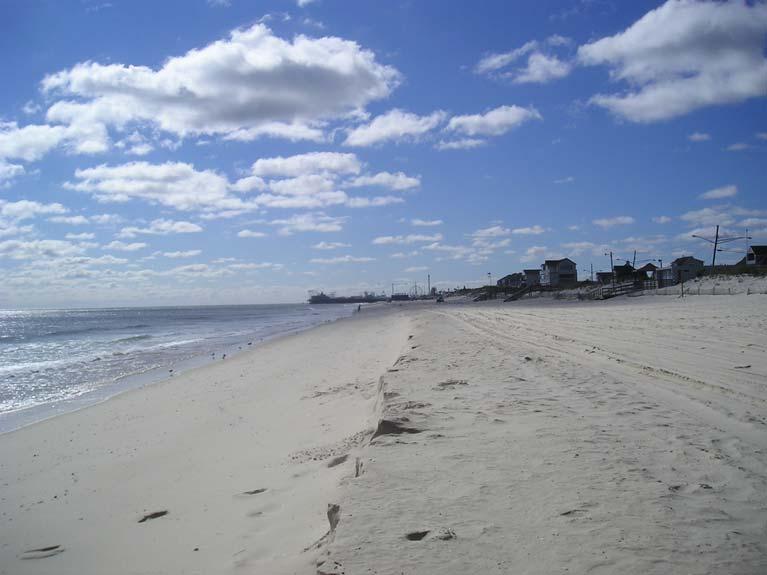 Figure 129. The Ortley Beach site has a modest dune that protects the boardwalk from minor storms. The beach is narrow enough to allow minor storms to impact the toe of the dune.
