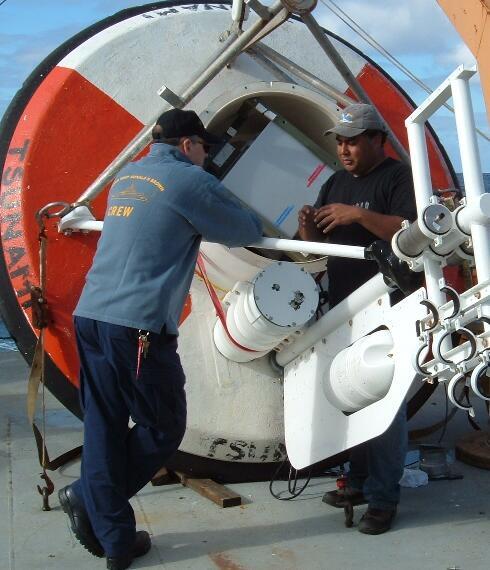 Fig 6-3: Working on the DART buoy As the SHOA team worked on the battery replacement of the Tsunami warning system, WHOI personnel replaced ASIMET sensors and batteries on the buoy.