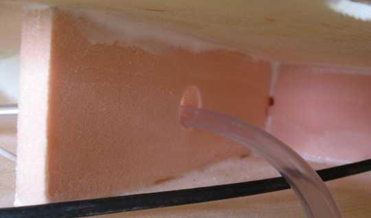 Lay the strake across the mounting stub. Locate the drawstring inside the fin that will be used for the VHF cable and the static tube it is tied in a loop around the internal foam rib.