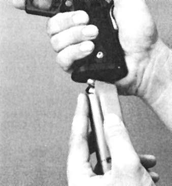 PREPARING TO FIRE - INSERTING THE MAGAZINE Keep the muzzle pointed away from yourself and in a safe direction. Do not use magazines that show signs of damage, cracking or excessive wear.
