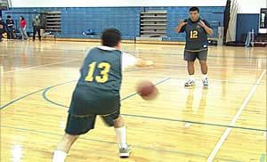 Teaching Two-Handed Bounce Pass 1. Hold a basketball with both hands, at chest height and under the chin. 2.