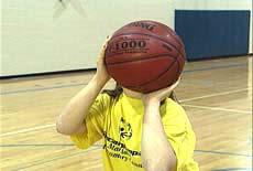 The shooting hand is behind and slightly under the ball; the non-shooting hand is to the