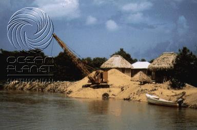 Mining sand from the shores of Belize for landfills in Central America.