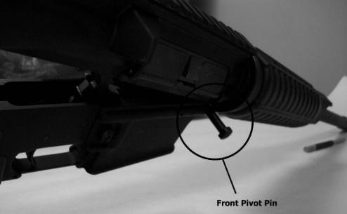 Slide the take down pin out, the firearm will now pivot forward (figure 8). 3.