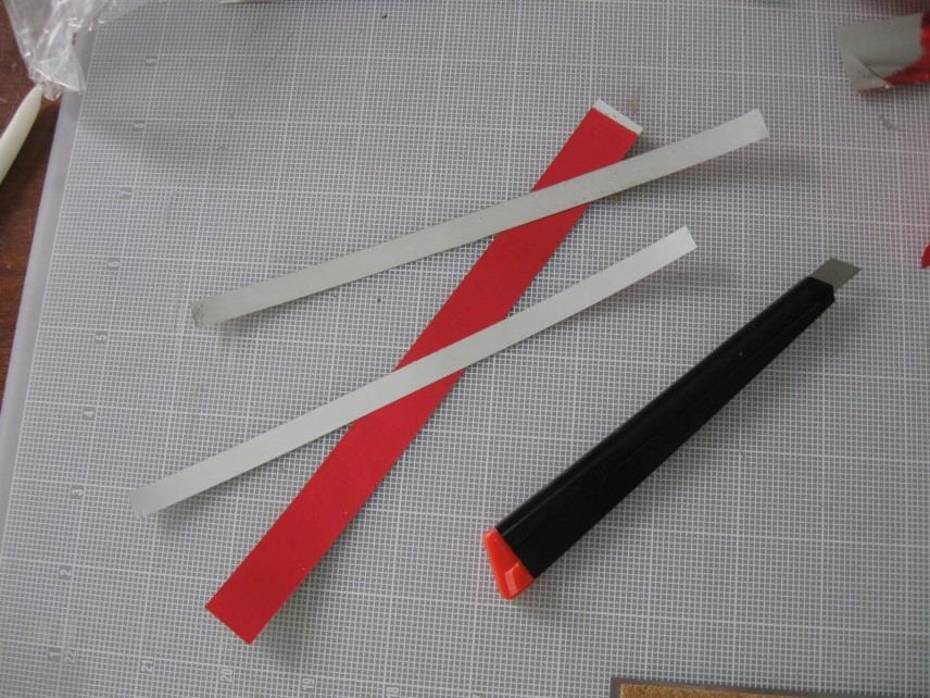 which are different colors. 34. Cut off two pieces of the tape, each ¾ to 1 inch long.